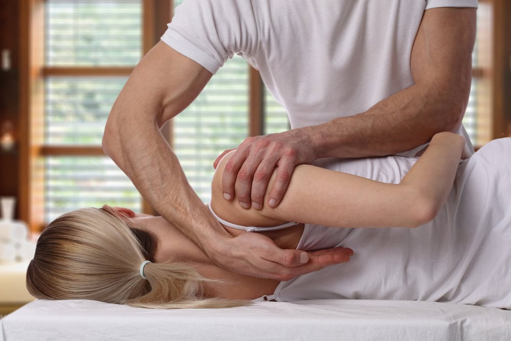 Woman,Having,Chiropractic,Back,Adjustment.,Osteopathy,,Alternative,Medicine,,Pain,Relief