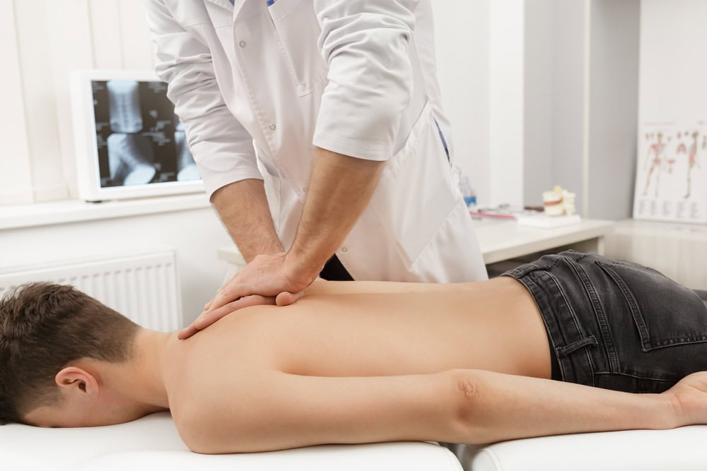 Manual,Therapist,Doing,Manual,Adjustment,On,Patient's,Spine.,Chiropractic,,Osteopathy,