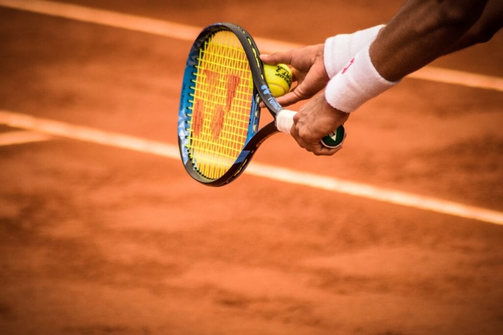 Person about to serve in tennis game